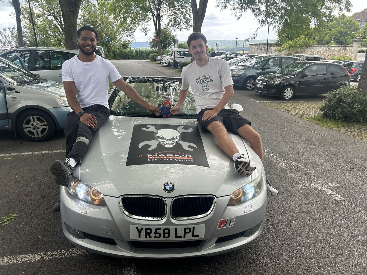 BMW rally car with team members